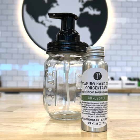 Foaming hand soap concentrate bottle with pump and label on a kitchen counter.