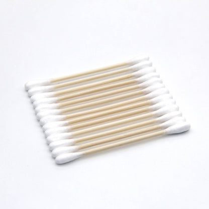 Set of cotton swabs with wooden handles on a white background