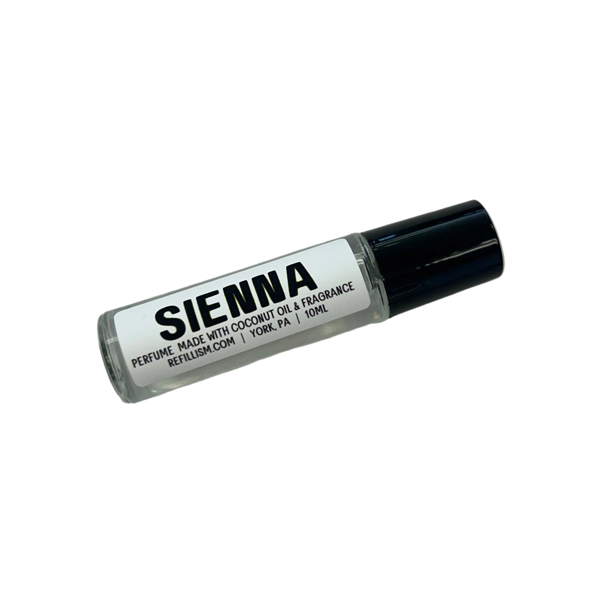 Small bottle labeled 'Sienna' on a gray surface with wooden side.