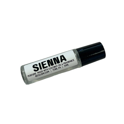 Small bottle labeled 'Sienna' on a gray surface with wooden side.