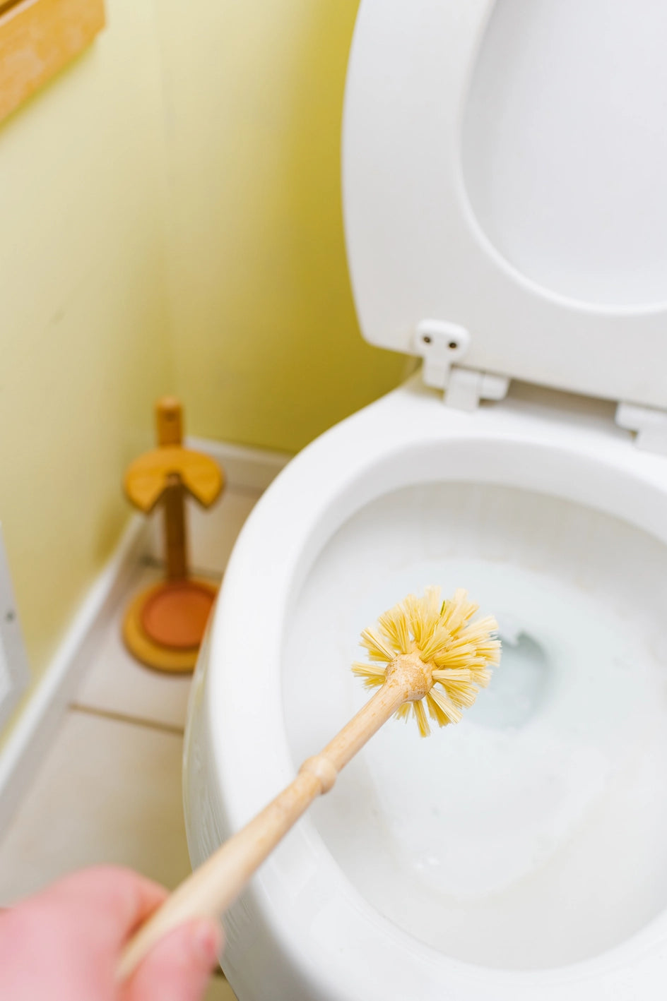 Close-up of the bamboo handle and sisal bristles on the eco-friendly toilet brush.