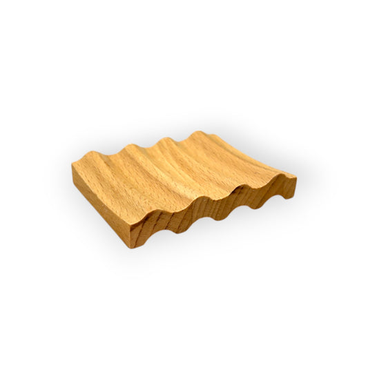 Wavy wooden soap dish with a natural rustic look.